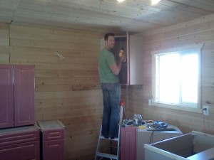 Mike installing the upper cabinets.
